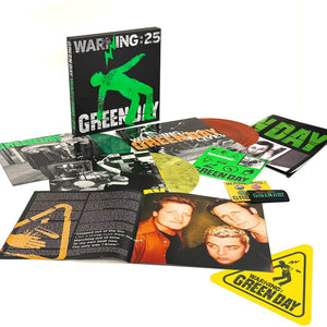 the album cover for Green Day - Warning (25th Anniversary Deluxe Edition) [Indie Exclusive Vinyl Box - Green, Yellow, and Orange LP]
